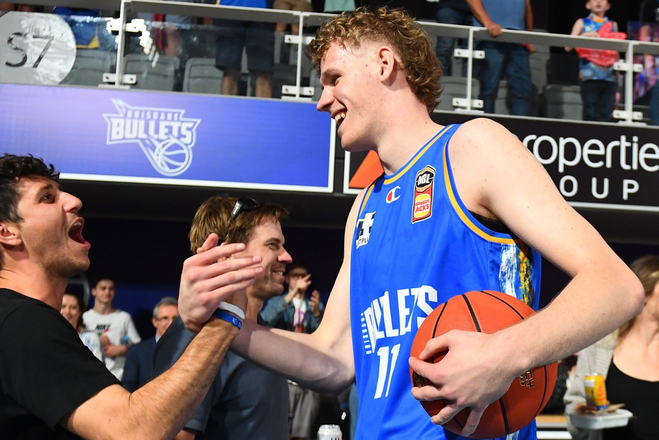 Rocco Zikarsky of the Bullets celebrates with fans after winning the round 1 NBL match between the Brisbane Bullets and Adelaide 36ers at Nissan Arena in Brisbane, Friday, September 29, 2023. (AAP Image/Jono Searle) 