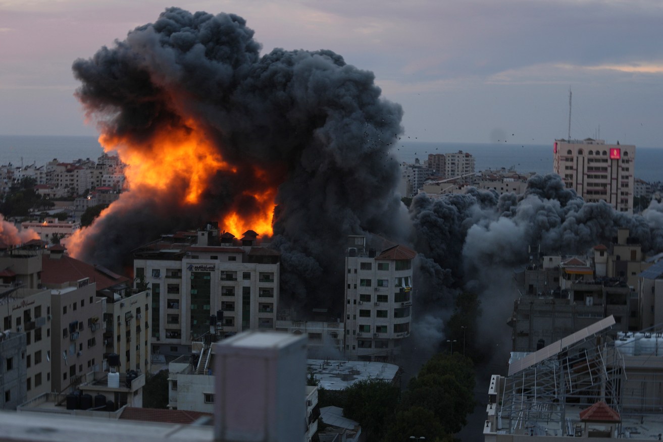 Fire and smoke rise from an explosion on a Palestinian apartment tower following an Israeli air strike in Gaza City, Saturday, Oct. 7, 2023. The militant Hamas rulers of the Gaza Strip carried out an unprecedented, multi-front attack on Israel at daybreak Saturday, firing thousands of rockets as dozens of Hamas fighters infiltrated the heavily fortified border in several locations by air, land, and sea and catching the country off-guard on a major holiday. (AP Photo/Adel Hana)