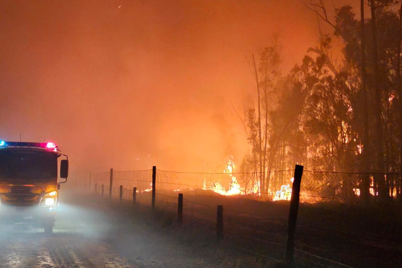 Bushfire, flooding and storm damage are pushing major insurers and banks towards a major financial crisis (AAP Image/Supplied by Queensland Fire and Emergency Services) 
