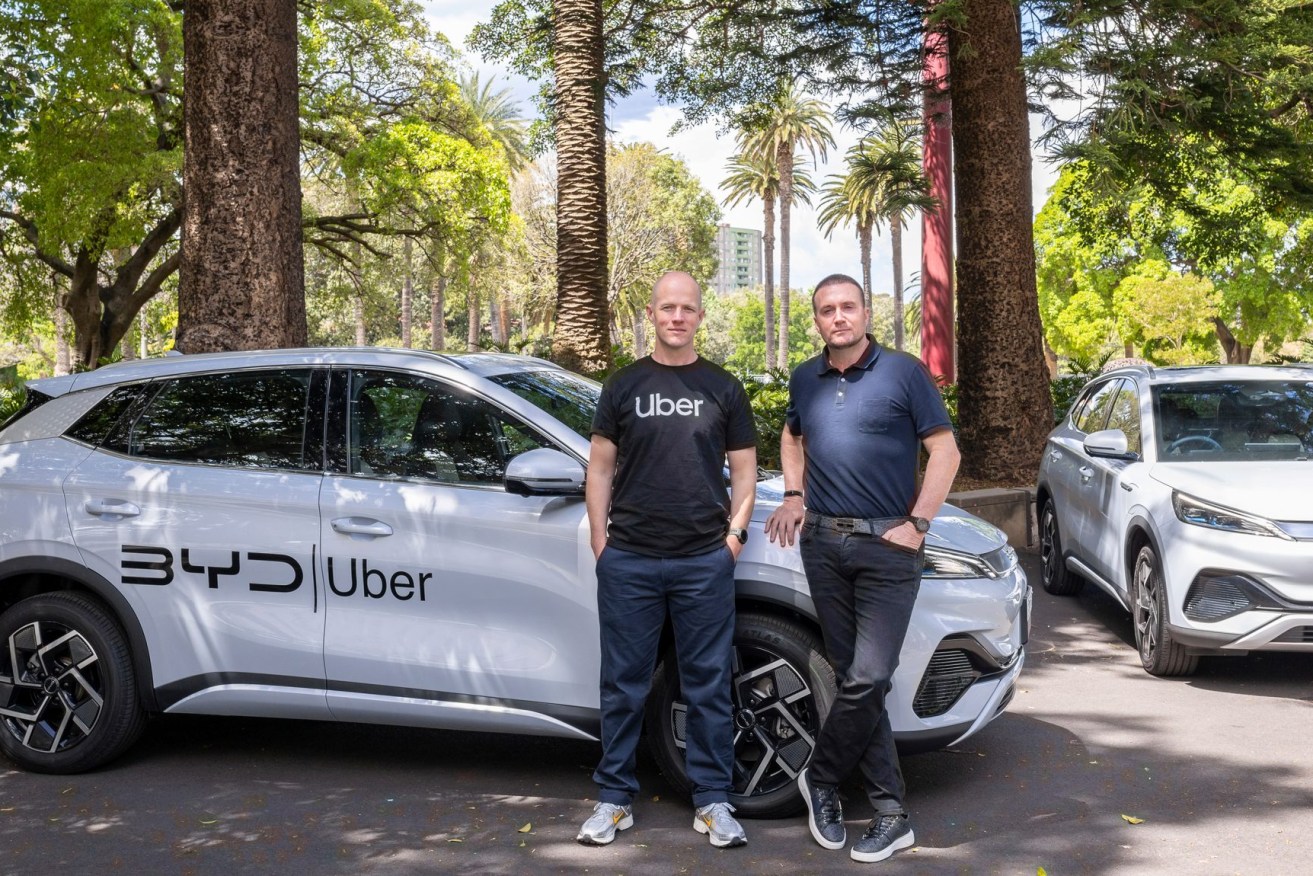 Uber Australia and New Zealand general manager Dom Taylor and EV Direct chief executive Luke Todd stand in front of a BYD Atto 3 electric vehicle. (AAP Image/Supplied by Uber) 