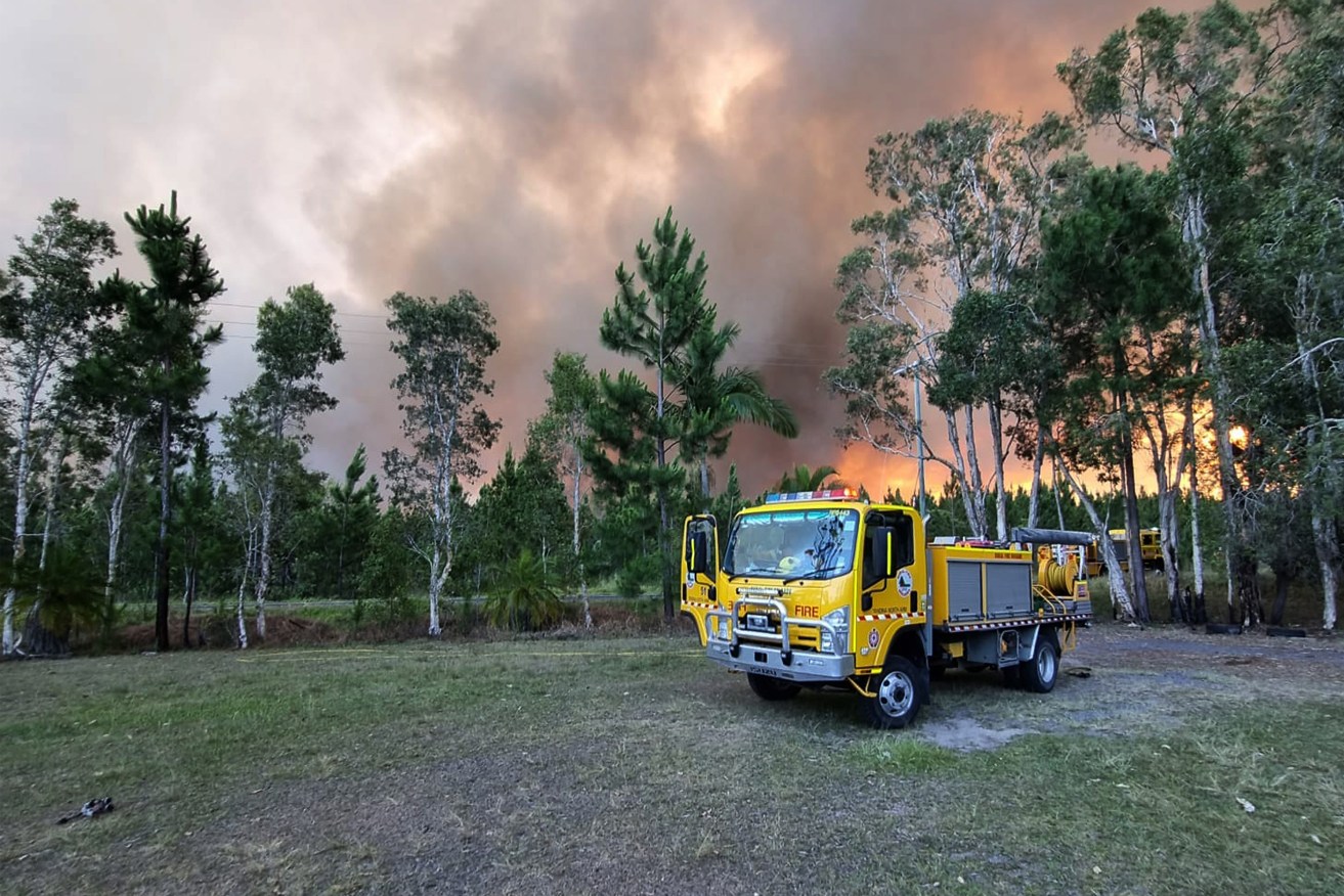 Firefights prepare to confront a blaze at Undullah. (AAP Image/Supplied by Queensland Fire and Emergency Services) 