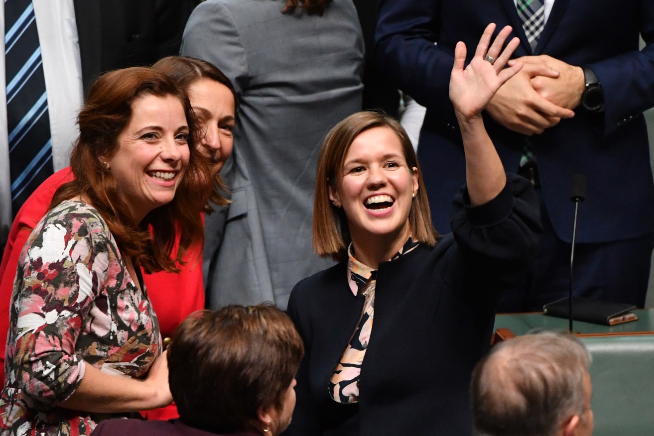 Labor Member for Jagajaga Kate Thwaites waves to her daughter after making her maiden speech in the House of Representatives at Parliament House in Canberra, Wednesday, July 24, 2019. (AAP Image/Mick Tsikas) NO ARCHIVING
