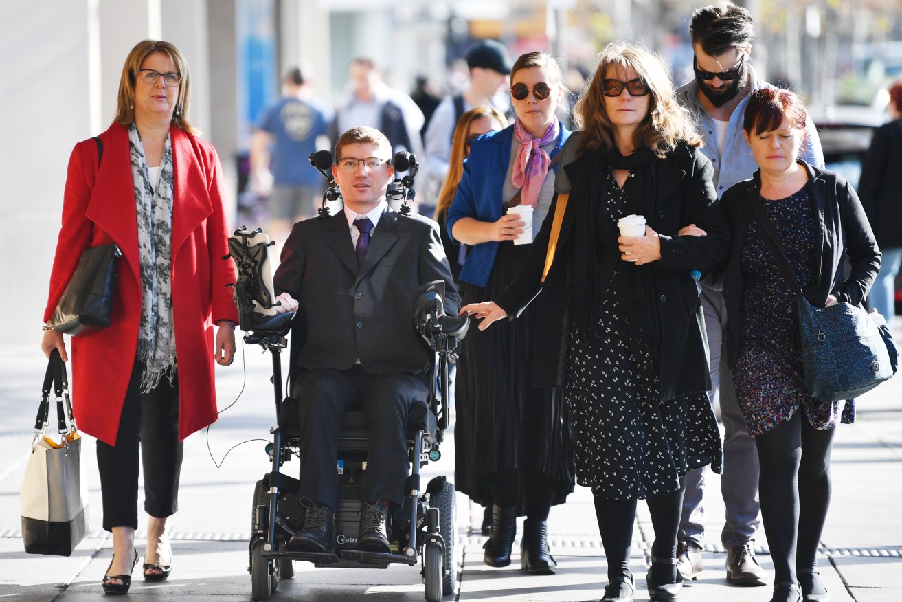 Jonathon Hawtin (second left) is seen outside the District court in Adelaide, Tuesday, August 6, 2019. (AAP Image/David Mariuz) 