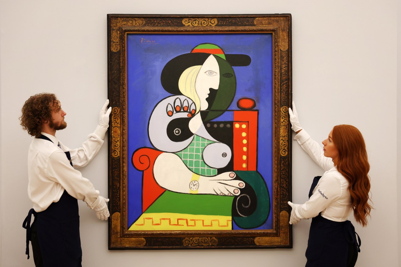 Sotheby’s auction house staff with Pablo Picasso’s ‘Femme a la montre’ (1932) during Sotheby’s Frieze Week Exhibitions in London, Britain, 06 October 2023. EPA/ANDY RAIN