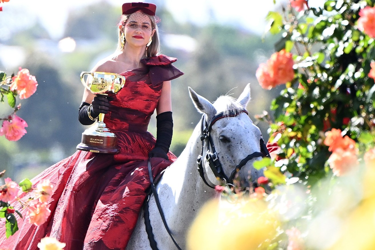 Jockey Michelle Payne arrives with the Melbourne Cup during the launch of the 2023 Melbourne Cup Carnival,.. (AAP Image/Joel Carrett) 