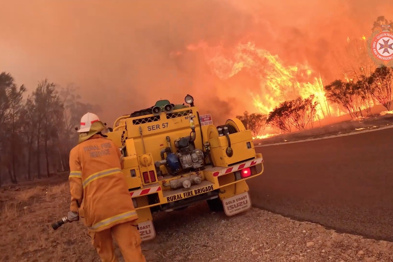 Extreme conditions are forecast as fires rage across Queensland for a second week, with more houses under threat as relief crews arrive to help. (AAP Image/Supplied by Queensland Fire and Emergency Services) 