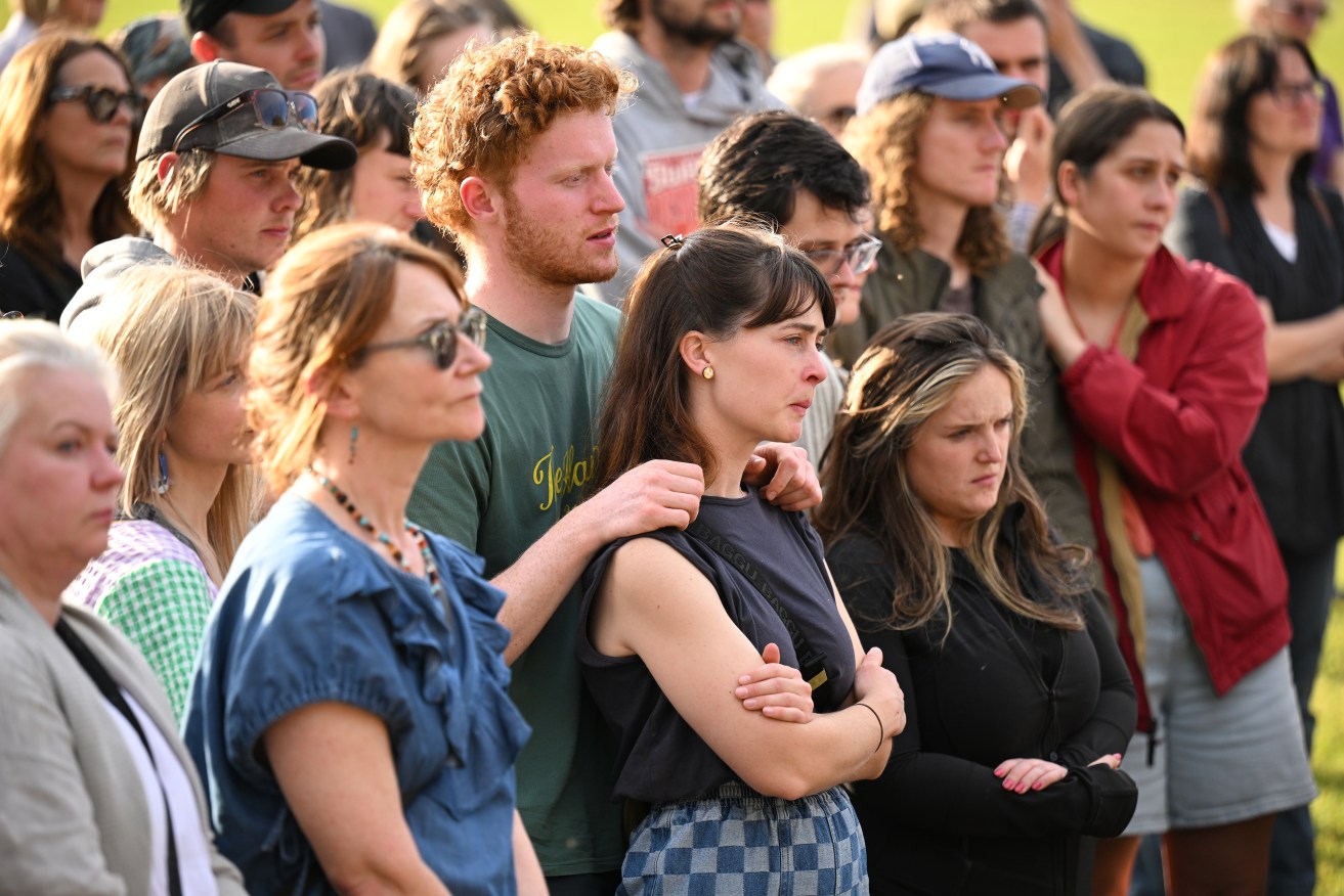 Mourners gather for a vigil at Victoria Park in Daylesford, Victoria, Monday, November 6, 2023. Five people, including two children, have died and there are multiple others injured after an SUV car crashed into a pub in regional Victoria. (AAP Image/James Ross) NO ARCHIVING