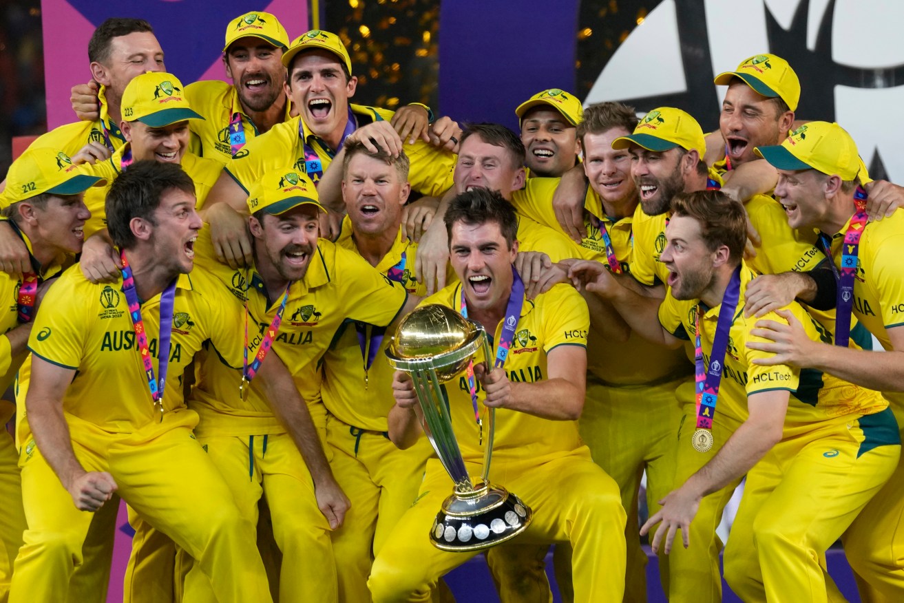 Australian players celebrate with the trophy after winning against India during the ICC Men's Cricket World Cup final match in Ahmedabad, India, Sunday, Nov.19, 2023. (AP Photo/Aijaz Rahi)