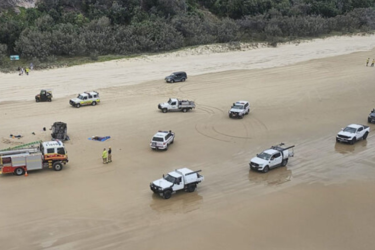 A supplied image shows emergency services responding to a fatal four wheel drive rollover at Teewah Beach north of Brisbane, Sunday (AAP Image/Supplied by RACQ LifeFlight Rescue)