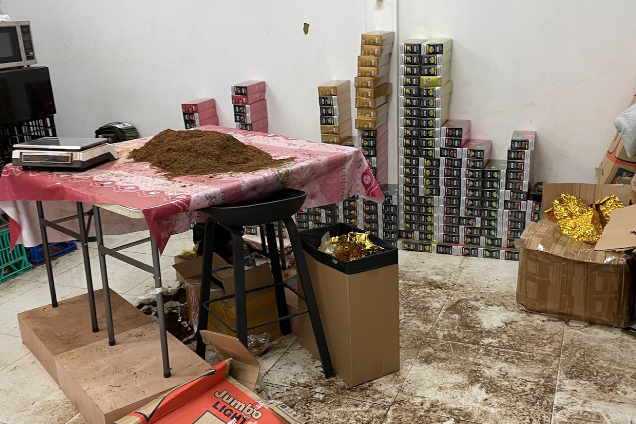 Seized items from a storage shed included tobacco (on table) and multiple vapes and casettes. (Image QCCC) 