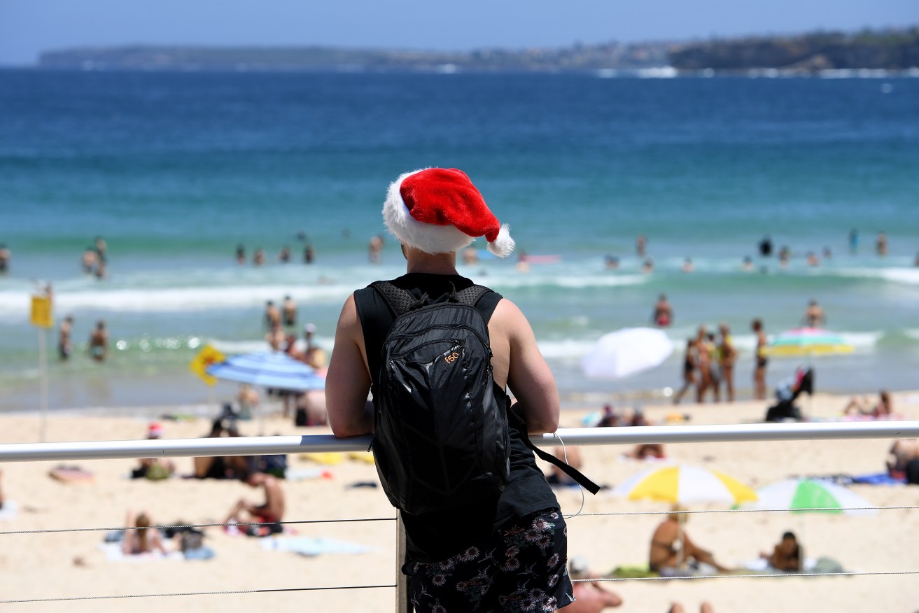 Beachgoers spend Christmas Day on Bondi Beach, in Sydney, Sunday, Dec. 25, 2016. (AAP Image/Dan Himbrechts) NO ARCHIVING