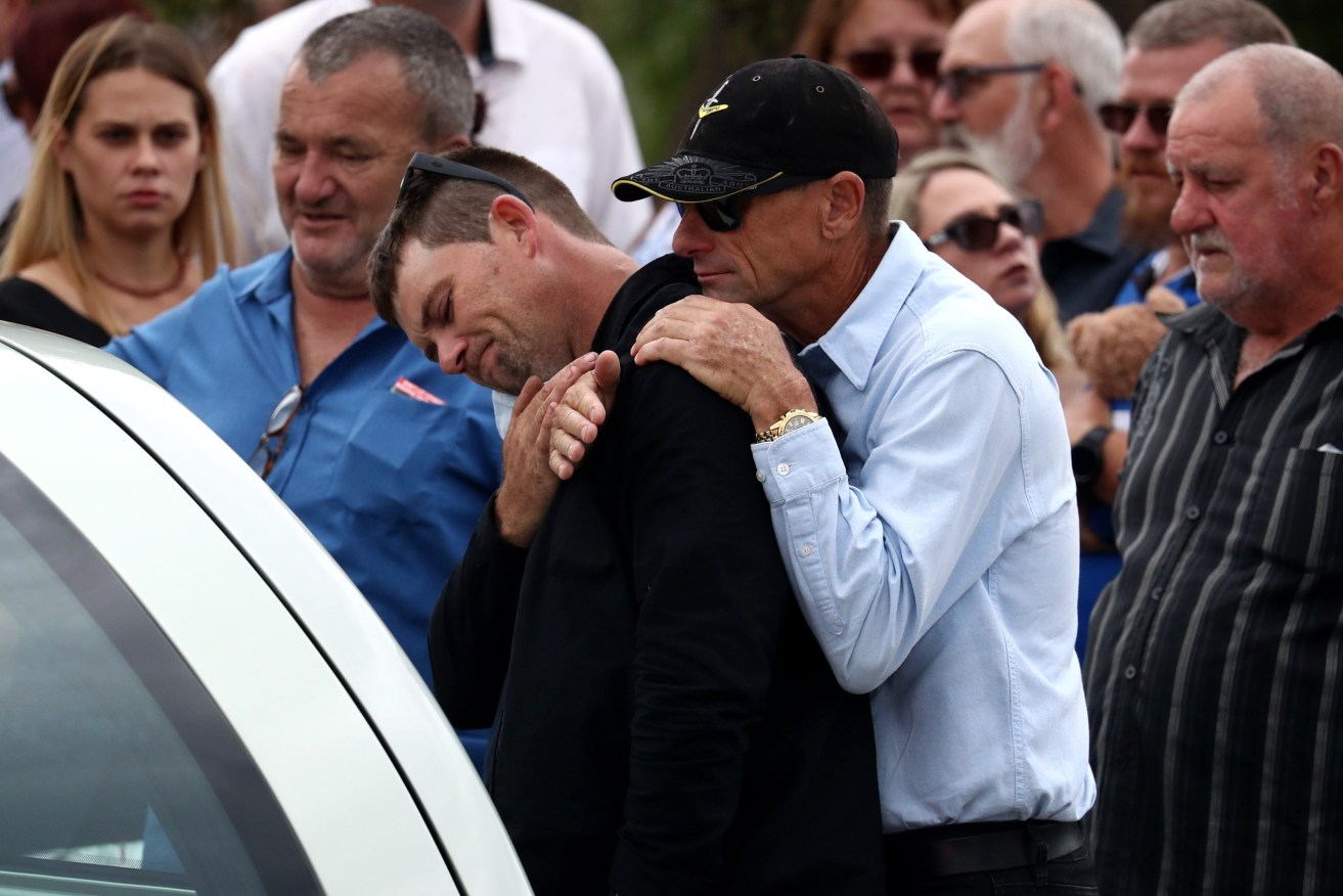 Corey Richards, stepson of Alan Dare, reacts at the funeral of the "good Samaritan" neighbour killed in Wieambilla shootings (AAP Image/Jason O'Brien) 
