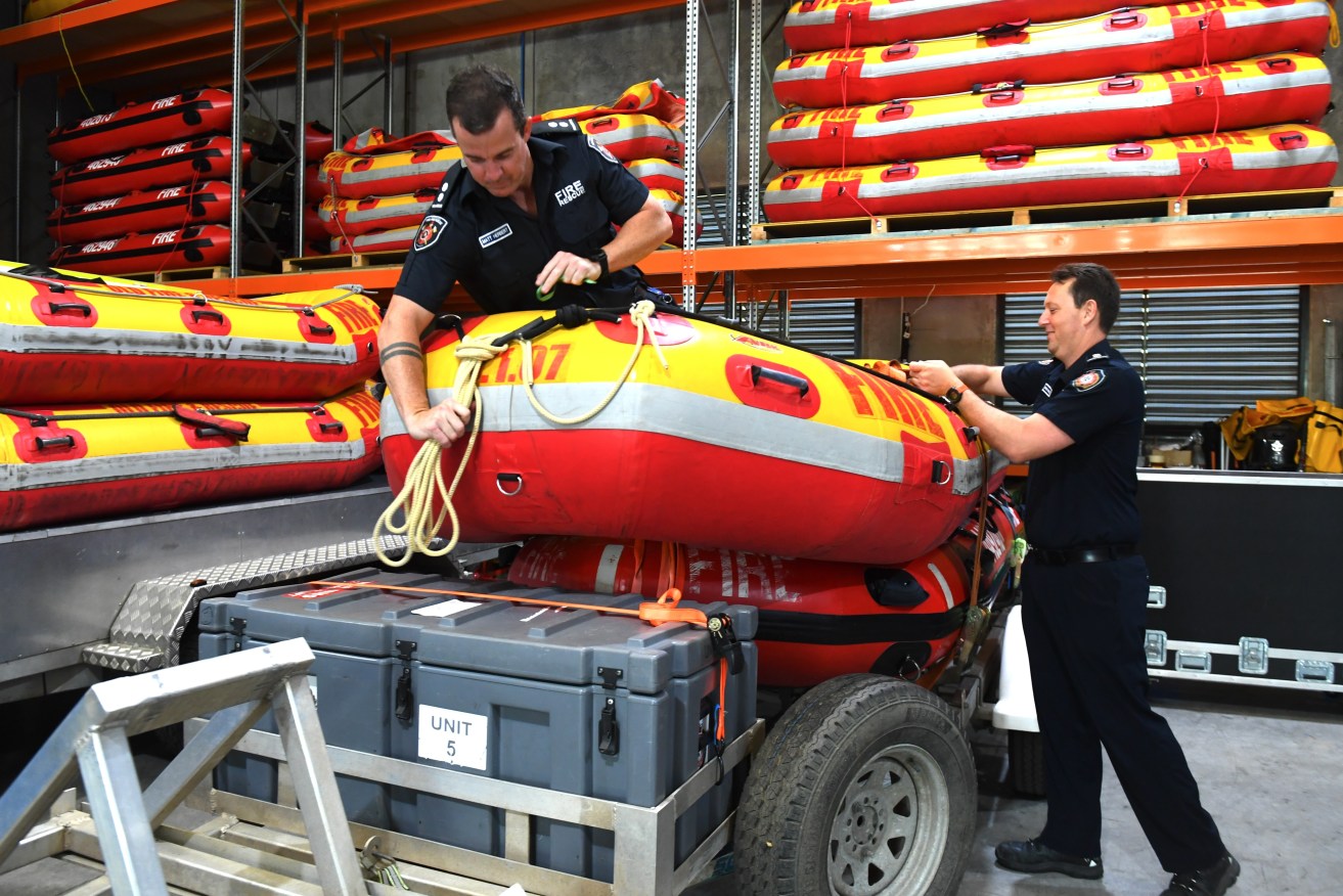 Fire and Rescue officers prepare swift water rescue boats) AAP Image/Jono Searle) 