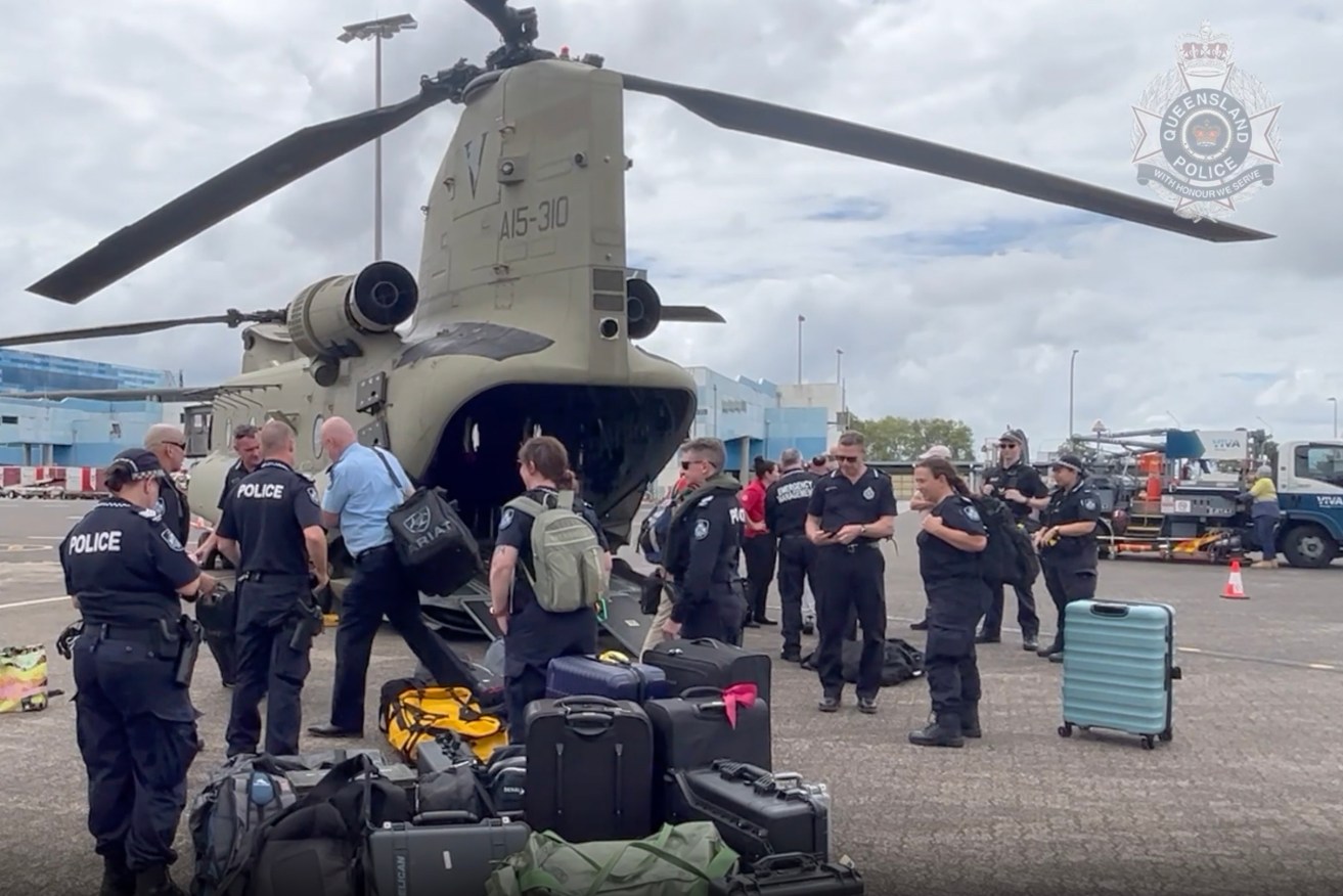  Police footage of QPS officers embarking on board ADF Chinooks to assist with evacuations and recovery efforts in Wujal Wujal, at Cairns Airport, QLD (AAP Image/Supplied by Queensland Police) 