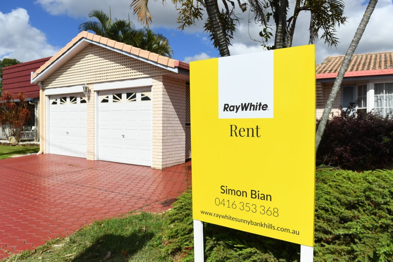 A rental sign is seen outside a house in Brisbane, Friday, February 10, 2023. Queensland housing advocates are calling for the state government to put limits on the amount and size of rent rises allowed each year. (AAP Image/Jono Searle) NO ARCHIVING