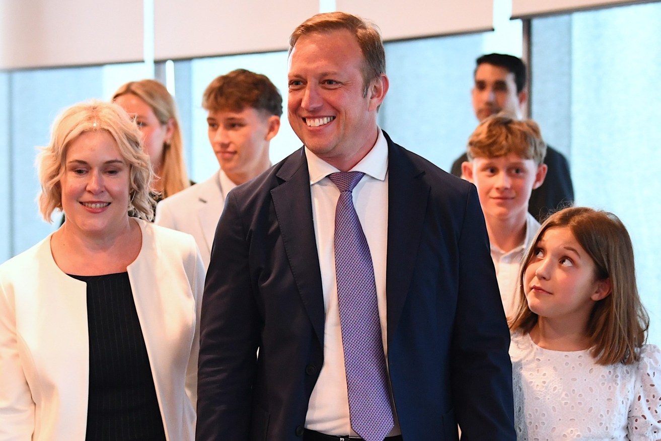 New Queensland Premier Steven Miles (centre) arrives with wife Kim, (left) and family as he makes his first address as Premier, at 1 William Street in Brisbane, Friday, December 15, 2023. (AAP Jono  Searle) 