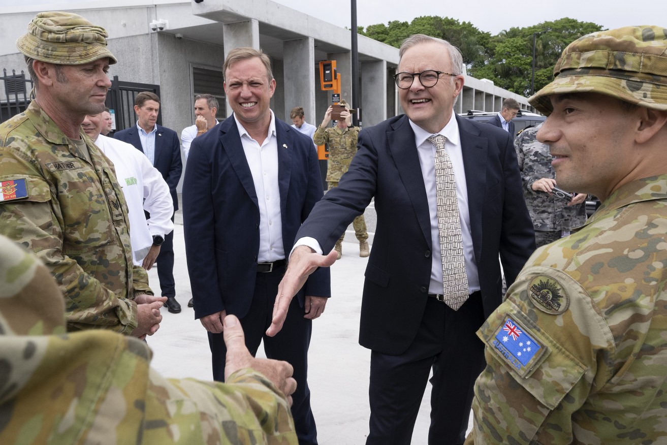 Australian Prime Minister Anthony Albanese meets ADF personnel as Queensland Premier Steven Miles have promised troops on the ground to help massive storm and flooding clean-ups at either end of the state.  (AAP Image/Dave Hunt) 