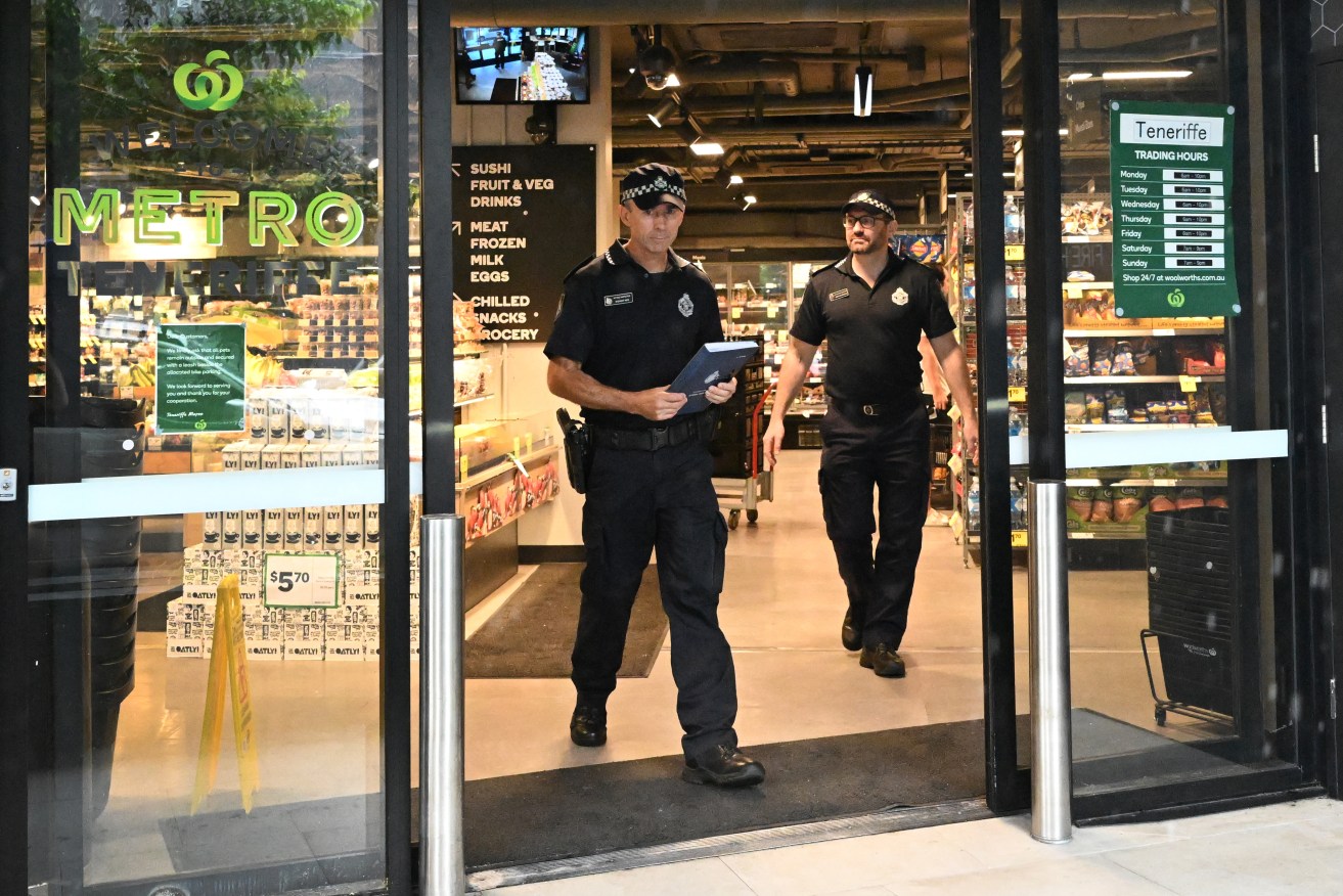 Police are seen at the Woolworths Metro store in the suburb of Teneriffe which has been tagged with profanities and pro-Australia Day graffiti in Brisbane, Monday, January 15, 2024. The Prime Minister has warned Opposition Leader Peter Dutton to consider the impact his call for a Woolworths boycott could have on supermarket workers. (AAP Image/Darren England) NO ARCHIVING