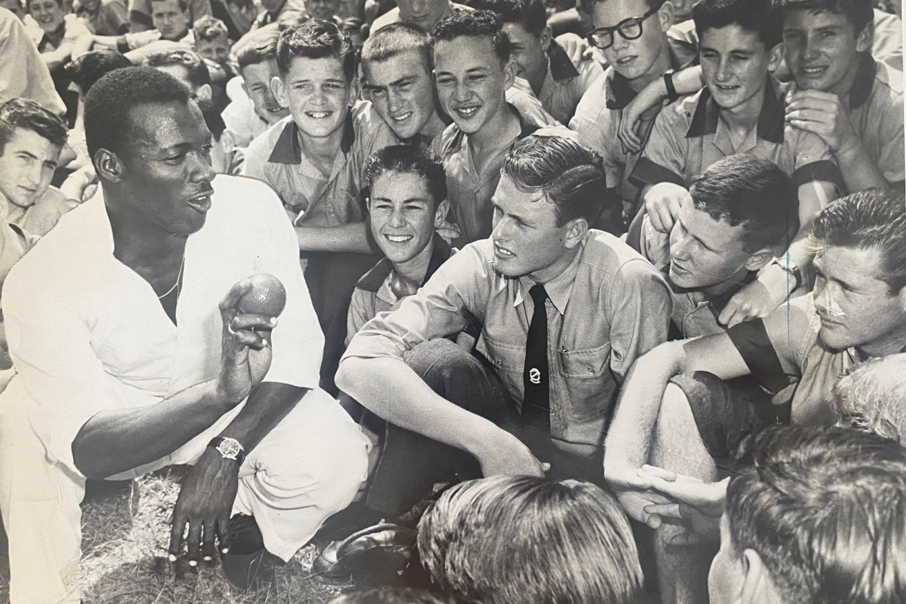 The great West Indian paceman Wes Hall captivating school kids at Brisbane’s Cavendish Road State High School in 1961. (Image: Supplied)