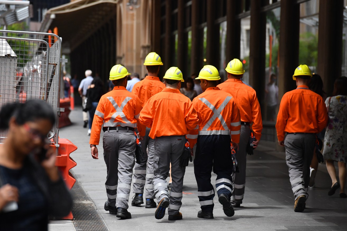 Construction site workers and office workers are seen at lunch break in Sydney, Wednesday, December 12, 2018. (AAP Image/Mick Tsikas) 