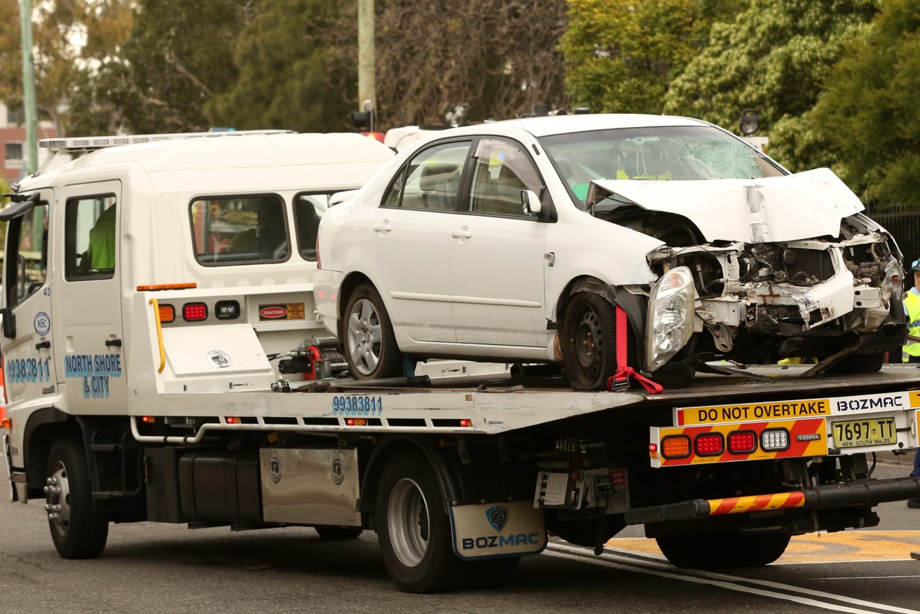 A car is seen on the back of a tow truck outside Hurstville Public School in Hurstville, Sydney, Friday, September 6, 2019. A 12-year-old boy has died after being hit by a car while crossing the road on his way to school in Sydney's south. (AAP Image/Danny Casey) NO ARCHIVING