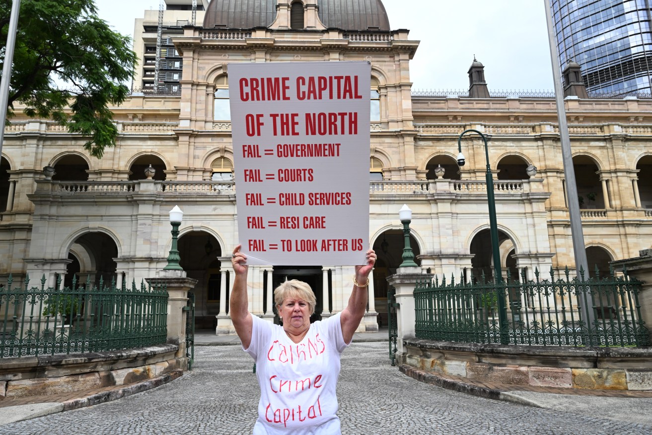 Perri Conti is seen protesting during an Anti Youth Crime Rally at Queensland Parliament, in Brisbane, Tuesday, February 21, 2023. . (AAP Image/Darren England)