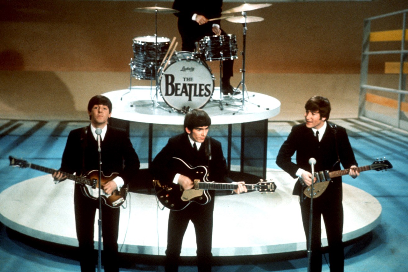 FILE -The Beatles, foreground from left, Paul McCartney, George Harrison, John Lennon and Ringo Starr on drums perform on the CBS "Ed Sullivan Show" in New York on  Feb. 9, 1964. (AP Photo/File)