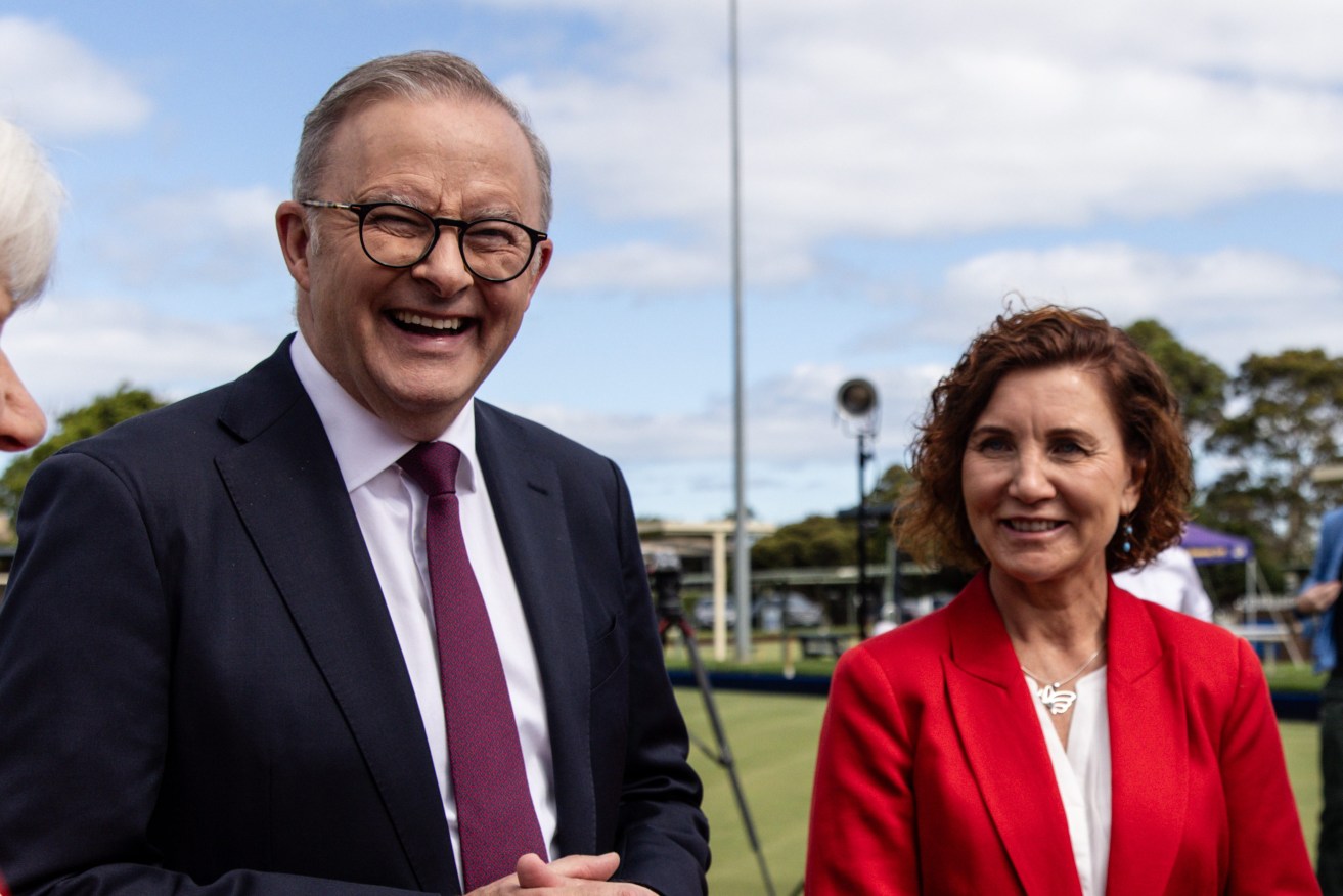 Australian Prime Minister Anthony Albanese (centre) and Candidate for Dunkley Jodie Belyea (right) pose for a photograph at the Frankston Bowling Club in Melbourne. (AAP Image/Diego Fedele) 