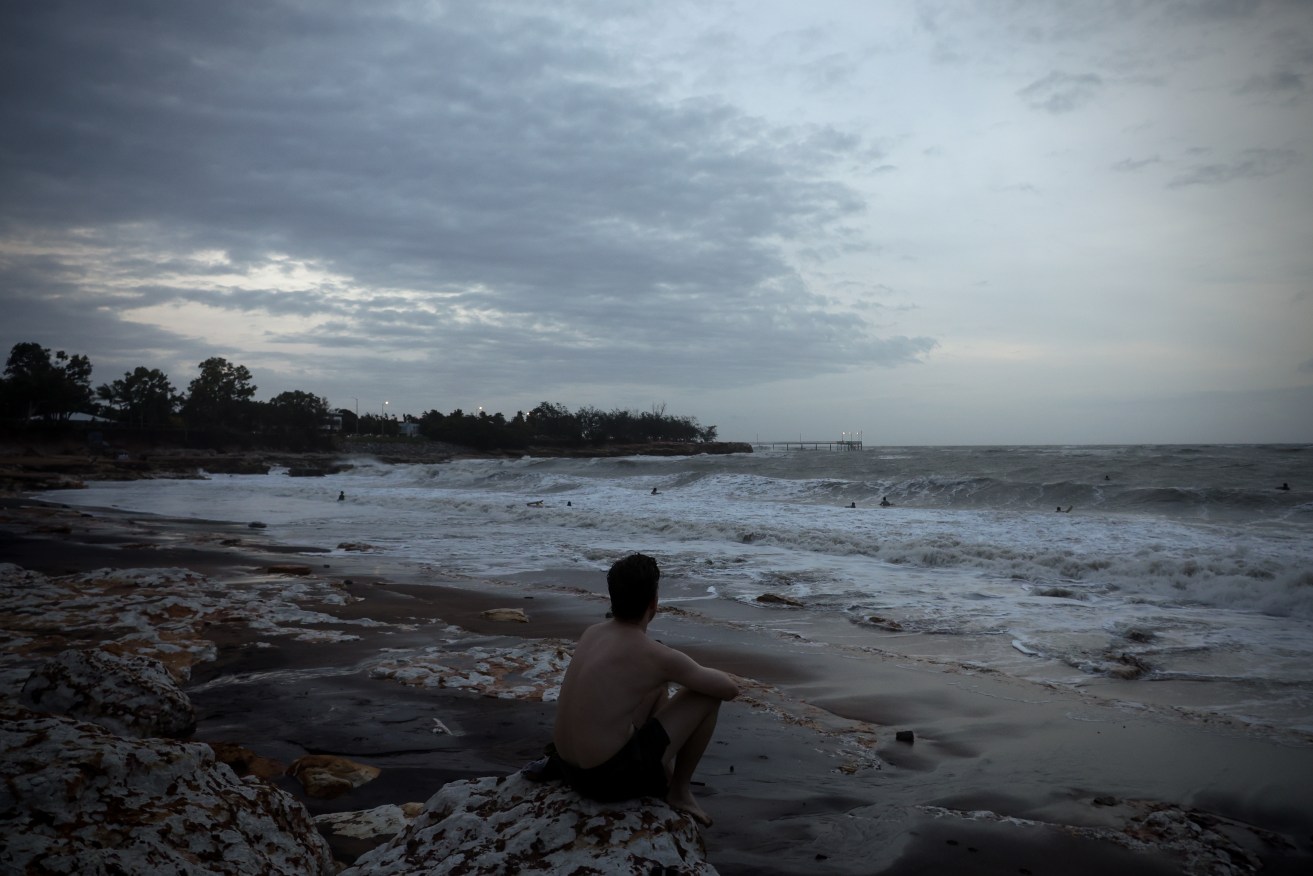 Surfers take to the water as storms sweep across the top end resulting in wild surf rolls at Nightcliff beach in Darwin, Wednesday, January 17, 2024. (AAP Image/Neve Brissenden) NO ARCHIVING