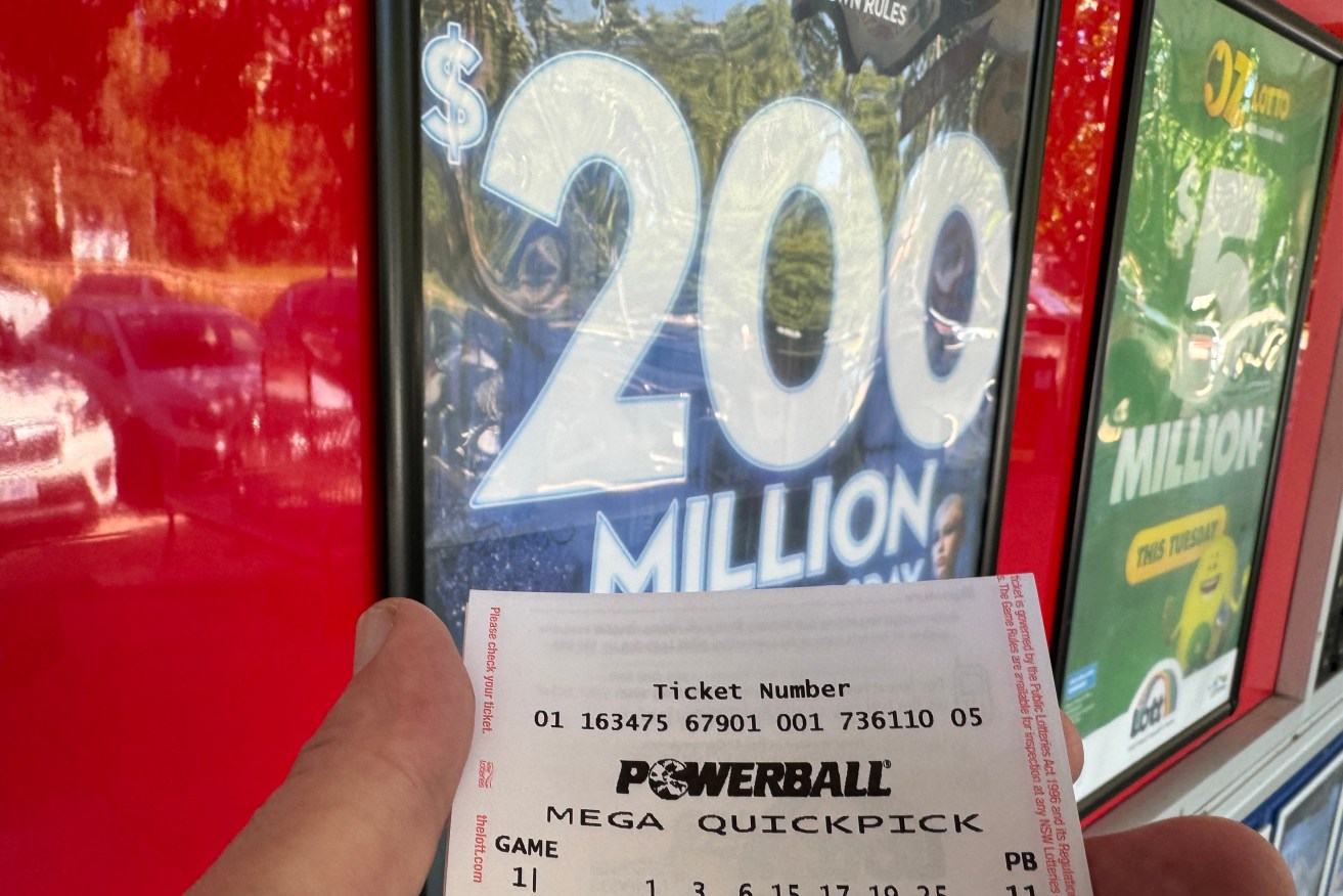 A newly purchased Powerball auto pick ticket is seen at newsagency in Canberra, Thursday, February 1, 2024. Powerball jackpots to $200 million this Thursday, after no major winners last week.(AAP Image/Mick Tsikas) NO ARCHIVING