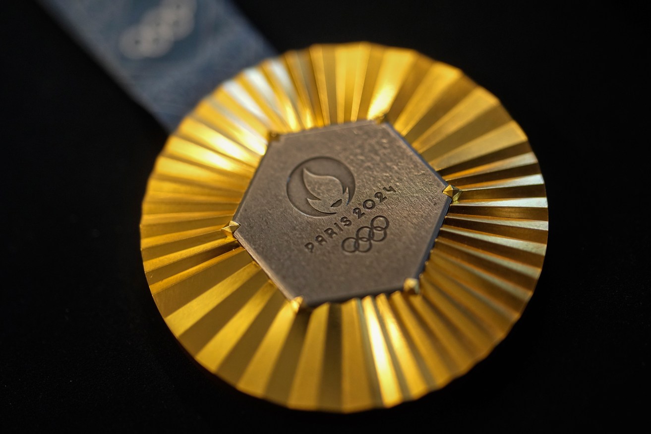 The Paris 2024 Olympic gold medal is presented to the press, in Paris, Thursday, Feb. 1, 2024. A hexagonal, polished piece of iron taken from the Eiffel Tower is being embedded in each gold, silver and bronze medal that will be hung around athletes' necks at the July 26-Aug. 11 Paris Games and Paralympics that follow. (AP Photo/Thibault Camus)