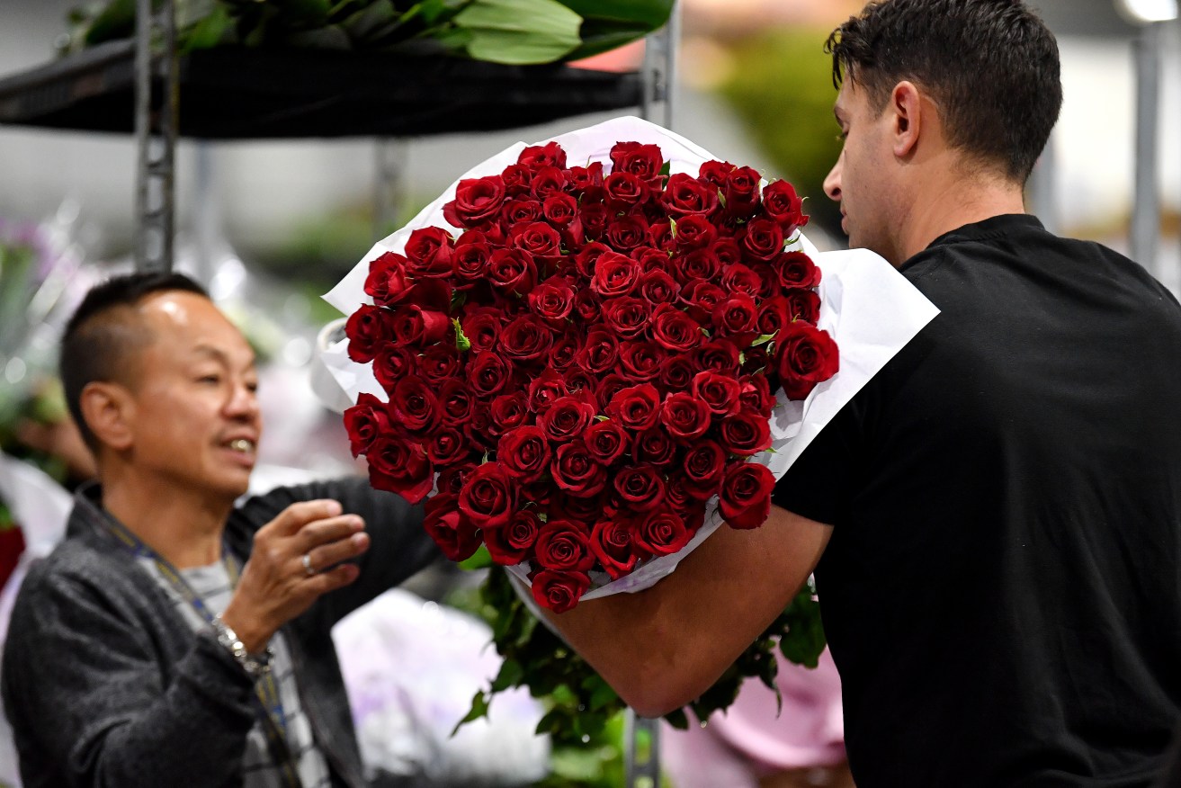 Flower traders sell roses to florists ahead of Valentine’s Day at the Sydney Flower Markets in Sydney, Monday, February 12, 2024. Preparation for Valentine's Day is in full swing with florists and traders gearing up on roses and florals for the busiest day of the year. (AAP Image/Bianca De Marchi) NO ARCHIVING