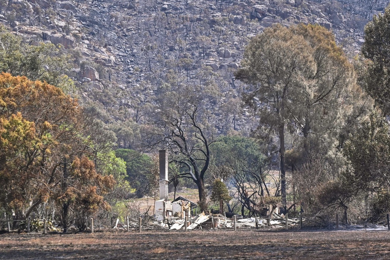 Fire damaged property is seen in Pomonal, Victoria, Thursday, February 15, 2024. Fire crews are hoping more favourable conditions will help extinguish three out-of-control bushfires in Victoria's west and central regions. (AAP Image/Pool/Justin McManus) NO ARCHIVING