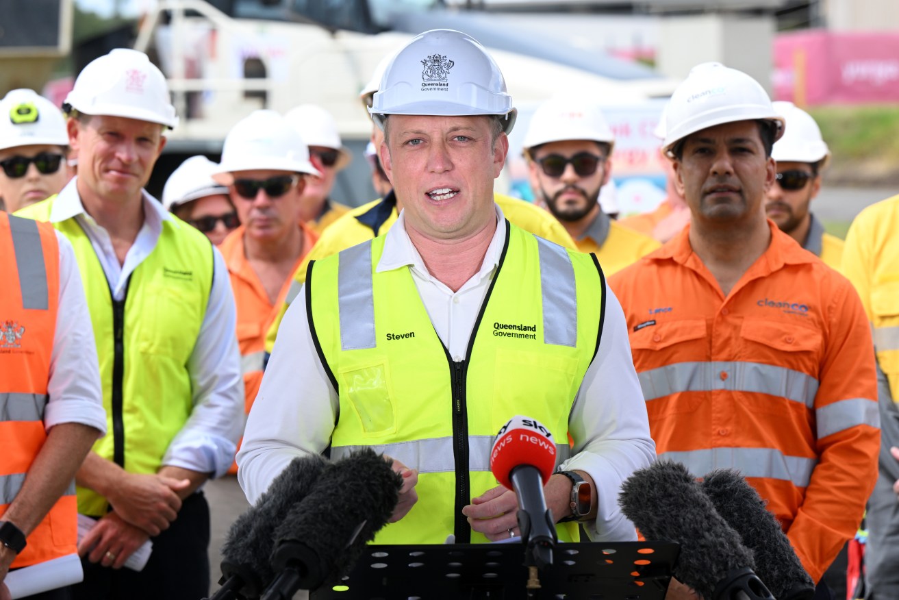 Queensland Premier Steven Miles (centre) speaks to the media during a press conference at Swanbank Power Station in Brisbane, Monday, February 19, 2024. The Premier has joined the Energy Minister and local MPs to mark the start of construction on a new big battery, in a partnership with Tesla and Yurika, Queensland’s publicly owned CleanCo will deliver the $330 million battery. (AAP Image/Darren England) NO ARCHIVING