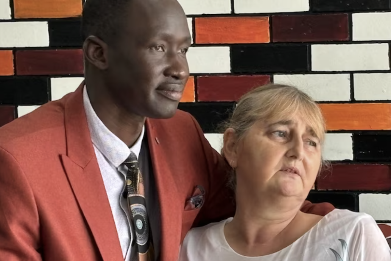 Queensland African Communities Council president Beny Bol with alleged murder victim Vyleen White's daughter Cindy.(ABC News: Michael Rennie)