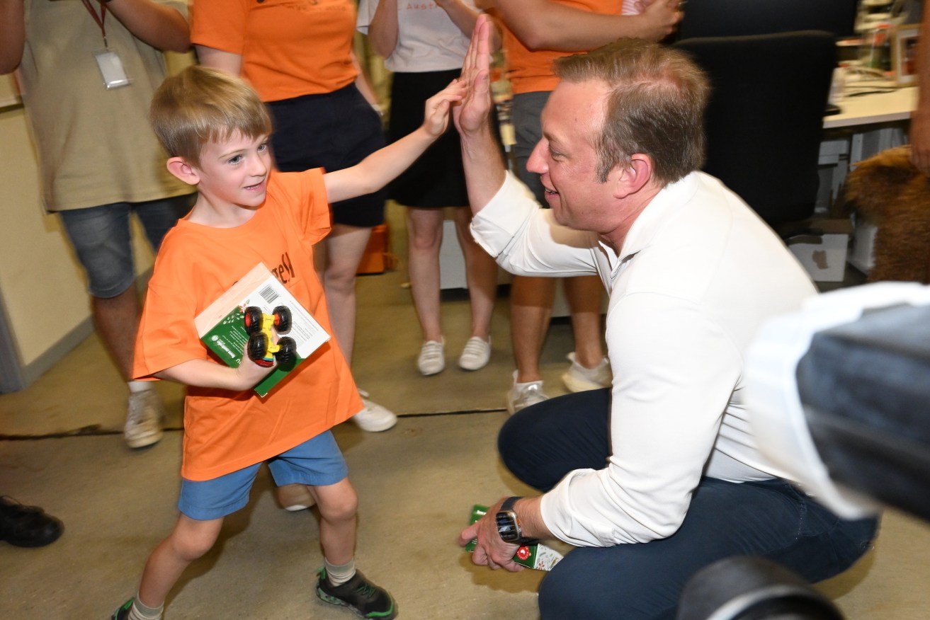 Queensland Premier Steven Miles is seen meeting families during an announcement with Orange Sky in Brisbane, Sunday, December 17, 2023. (AAP Image/Darren England) 