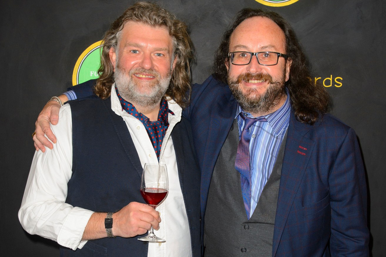FILE - Hairy Bikers, Si King, left and Dave Myers, pose for a photo at the Fortnum and Mason Food and Drink Awards, in Piccadilly, central London, May, 13, 2014.  Myers, best known as one half of Britain’s adored “Hairy Bikers” TV chef duo, has died after a battle with cancer. He was 66. His co-star and long-time friend Si King said in a post on social media that Myers died peacefully at home Wednesday, Feb. 28, 2024. Myers and King found fame in the U.K. and beyond with their “Hairy Bikers” TV series, an unlikely combination of motorbike travel show, humor and cookery program. (Dominic Lipinski/PA via AP, File)