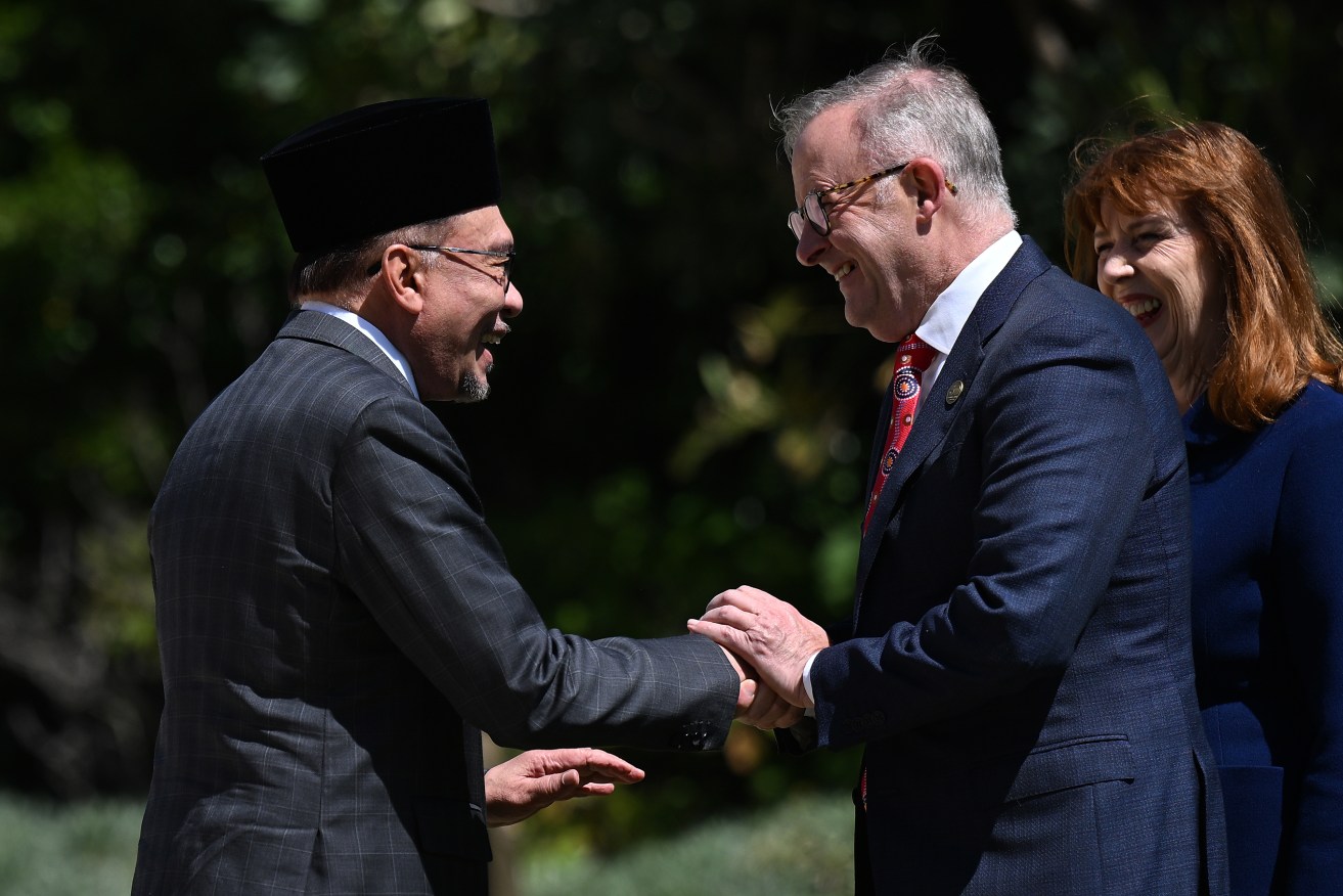 Australian Prime Minister Anthony Albanese (centre) greets Malaysian Prime Minister Anwar Ibrahim (left) during a ceremonial welcome ahead of the Australia-Malay annual leaders meeting . (AAP Image/James Ross) 