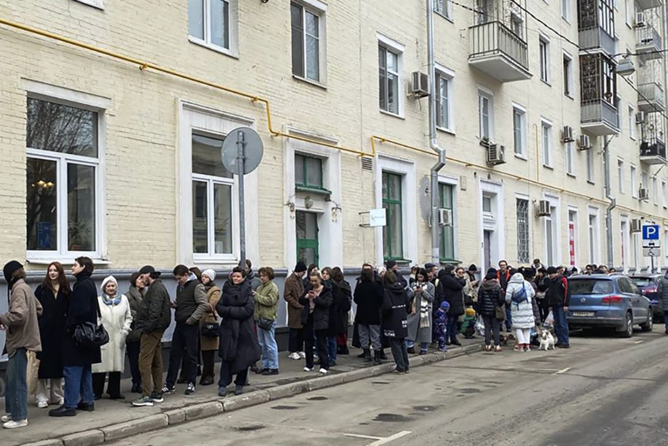 Voters queue at a polling station in Moscow. The Russian opposition has called on people to head to polling stations at noon on Sunday in protest as voting takes place on the last day of a presidential election . (Validated UGC via AP)
