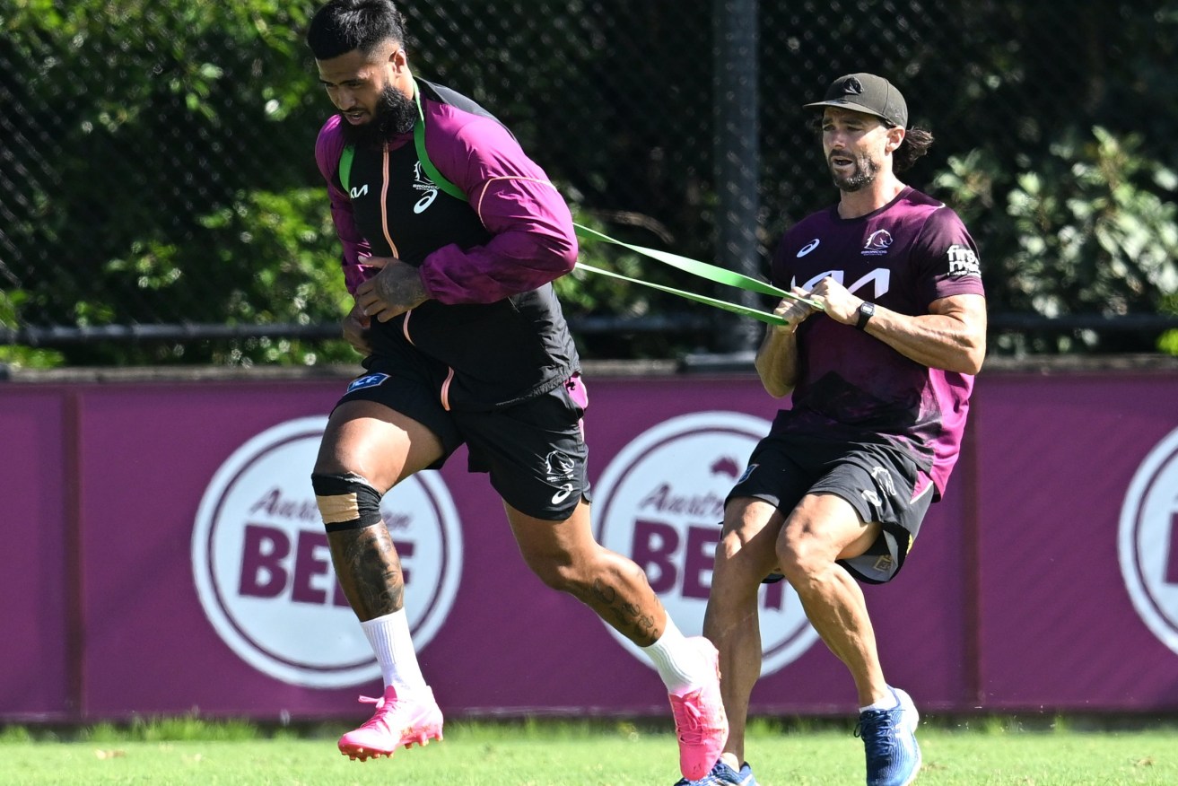 Payne Haas (left) is seen during a Brisbane Broncos NRL training session at Clive Berghofer Field in Brisbane, Wednesday, March 20, 2024. (AAP Image/Darren England) 