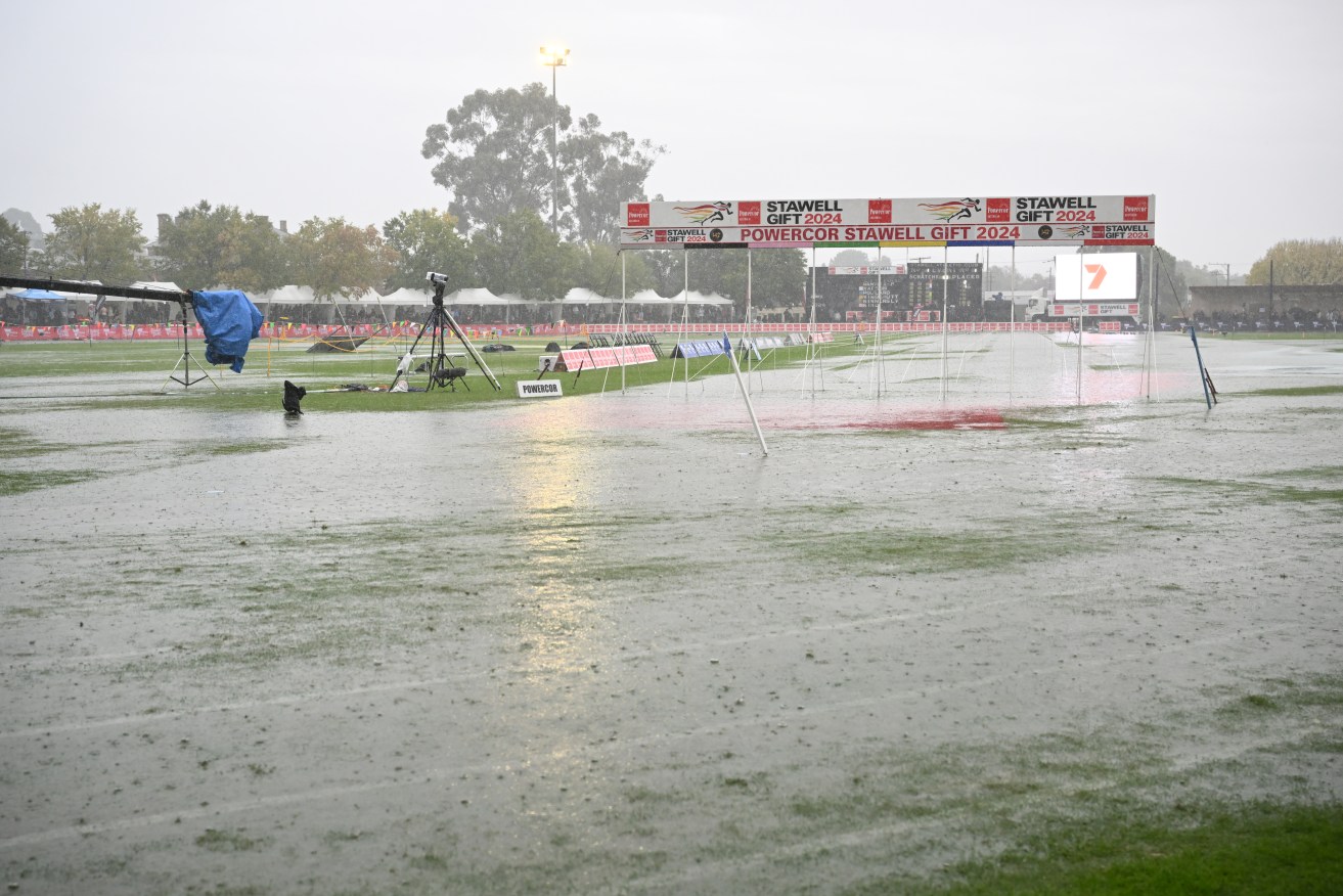 Water covers the running track as rain delays races during the 142nd running of the Stawell Gift at Central Park, Stawell,Victoria, Monday, April 1, 2024. (AAP Image/Joel Carett) NO ARCHIVING, EDITORIAL USE ONLY