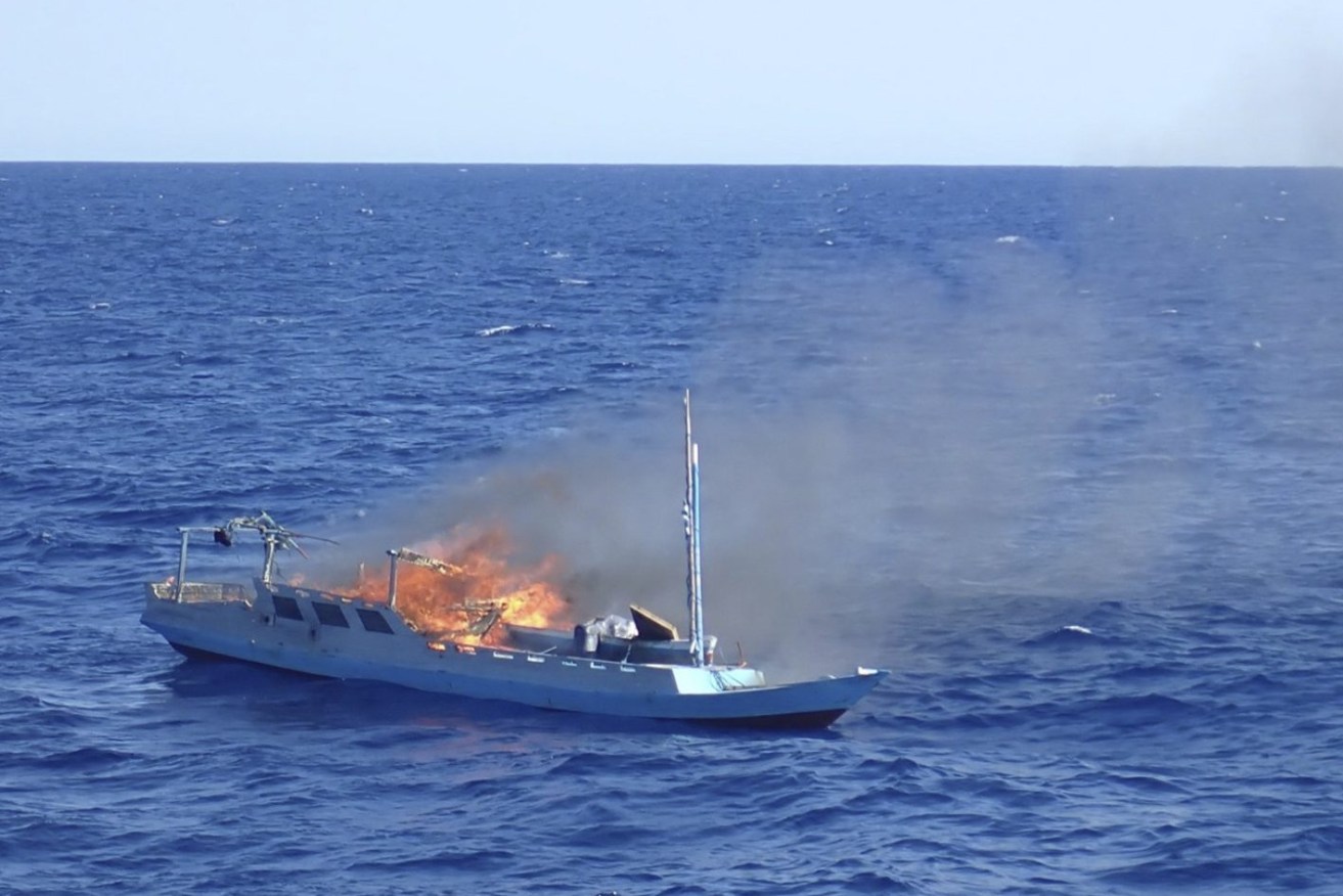 In this photo made available by the Australian Border Force on Nov. 2, 2021, a foreign vessel accused of fishing illegally in the vicinity of Rowley Shoals of Australia, is set on fire after its crew was taken off. Countries like Indonesia, Malaysia and Australia try to deter illegal fishing by making a spectacle of their enforcement, lining confiscated boats with explosives and setting them aflame. (Australian Border Force via AP)