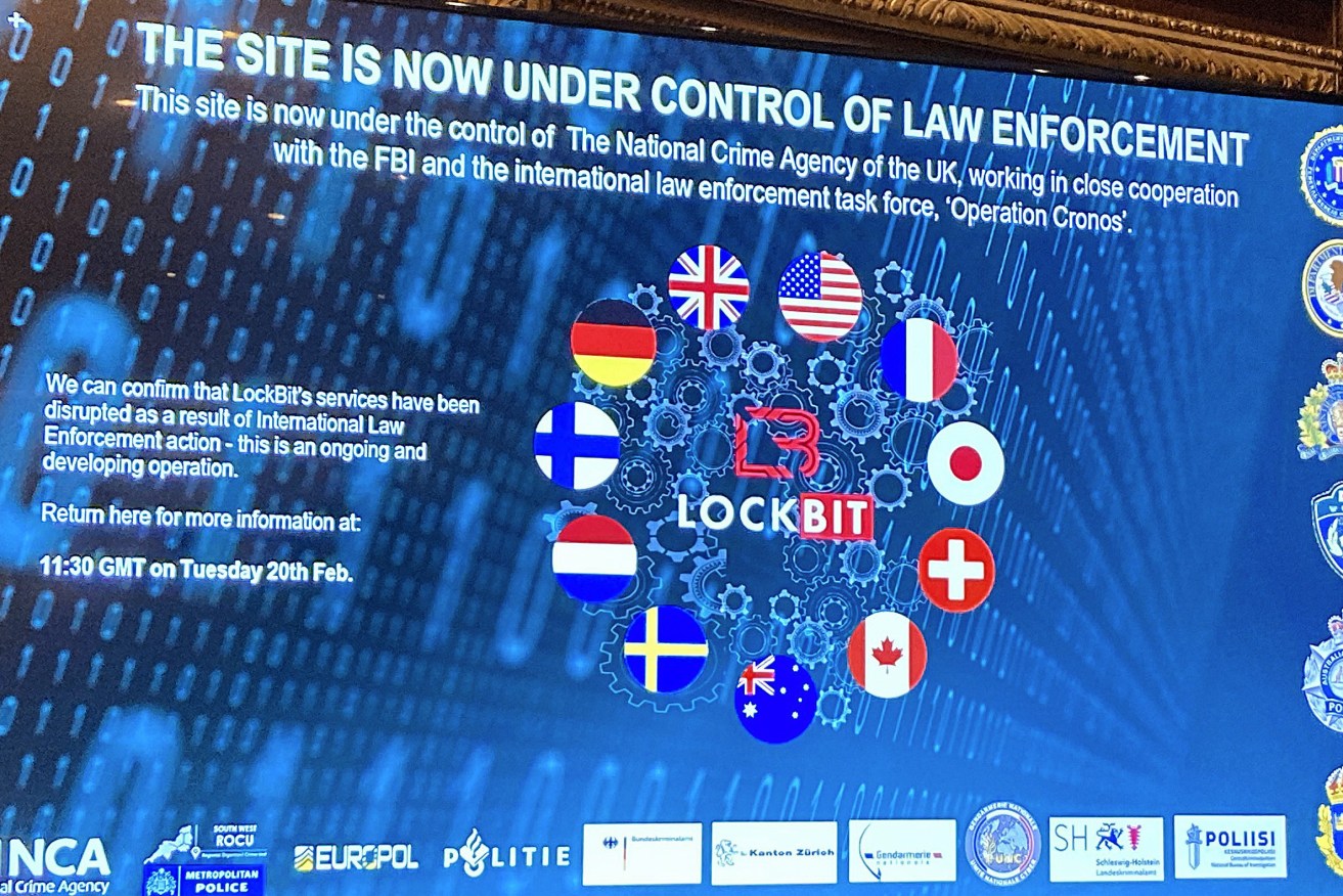  LockBit's dark-web leak site that was replaced with the words "this site is now under control of law enforcement," alongside the flags of the U.K., the U.S. and several other nations during the law enforcement press conference (AP Photo/Kelvin Chan)