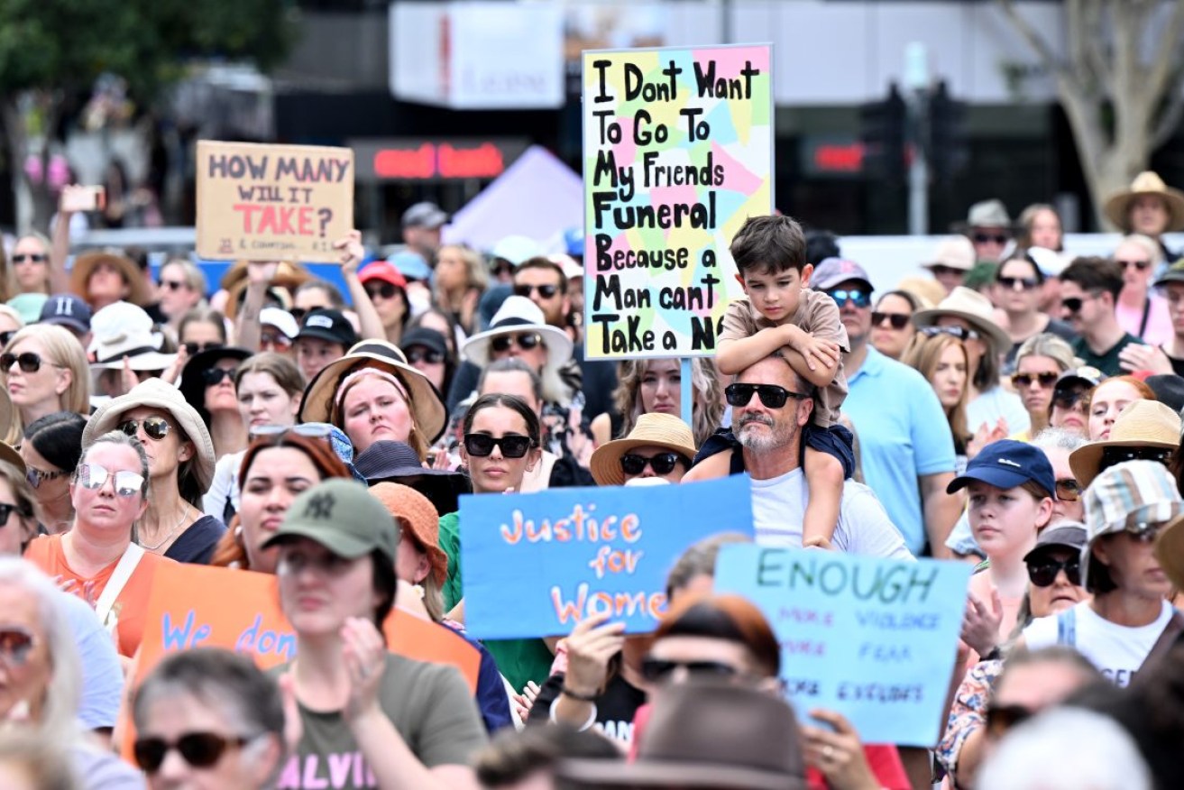People are seen during a rally to a call for action to end violence against women, at King George Square in Brisbane, Sunday, April 28, 2024.(AAP Image/Darren England) NO ARCHIVING