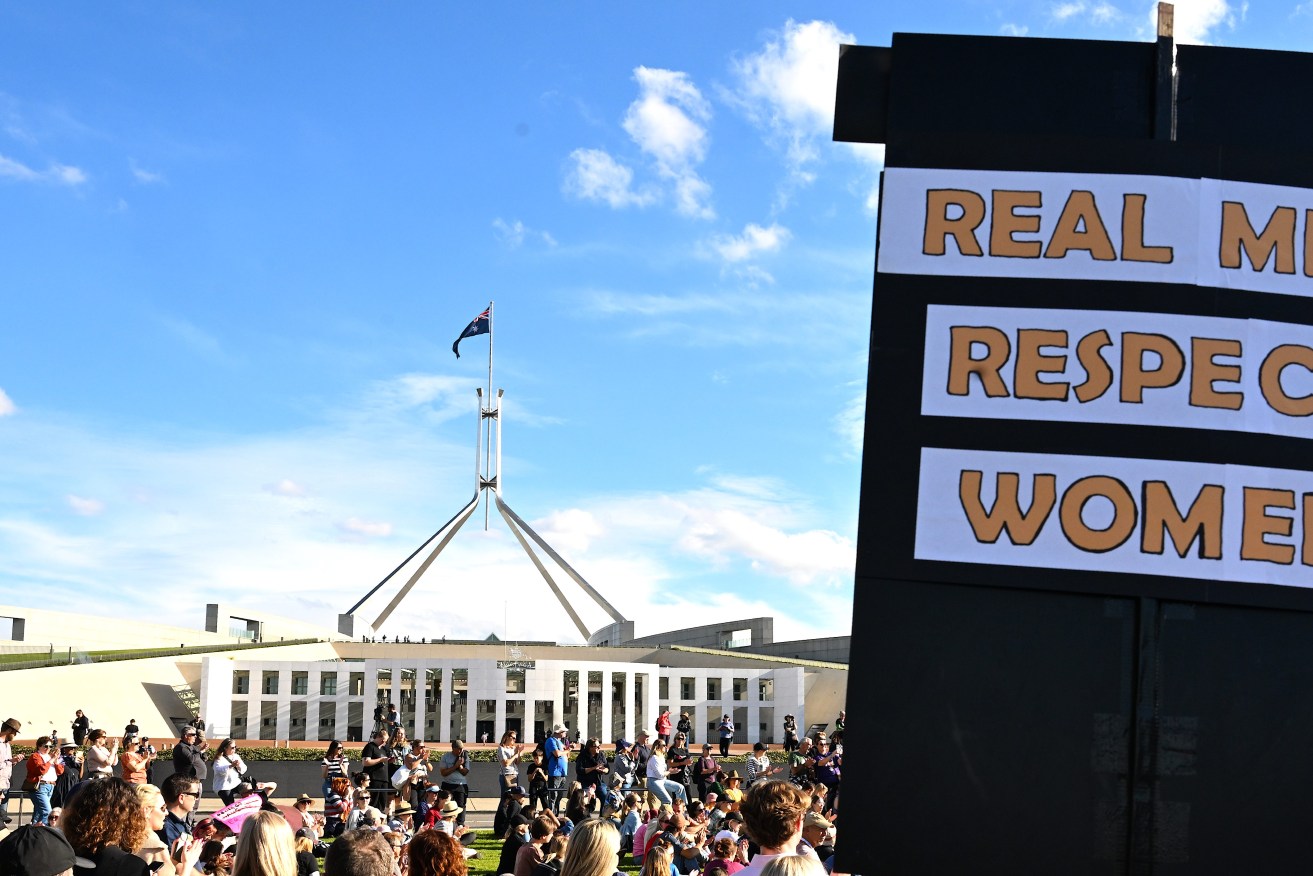 A general view of people attending a rally to a call for action to end violence against women outside Parliament House in Canberra, Sunday, April 28, 2024. (AAP Image/Lukas Coch) 