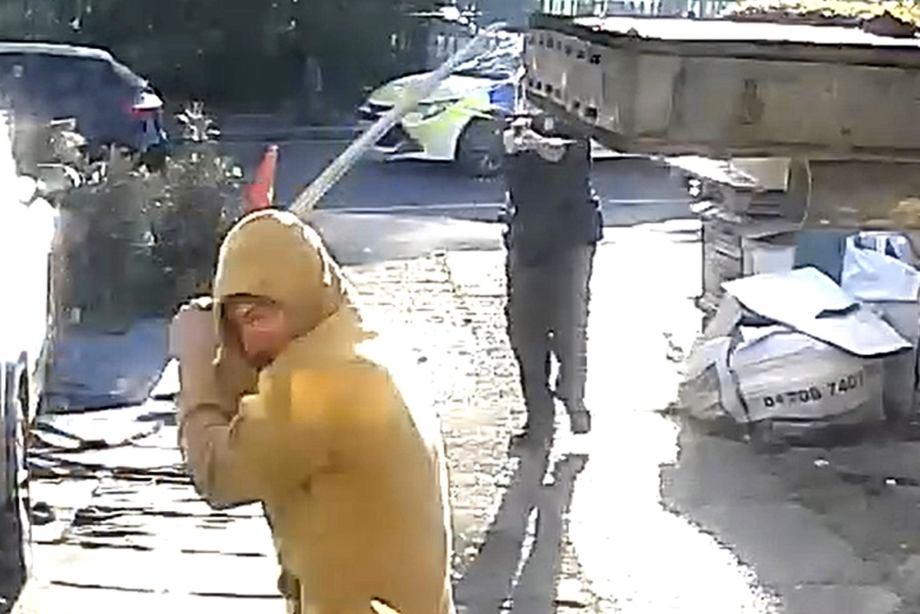 Handout footage from a doorbell camera of police officers tasering a sword-wielding man in Hainault, north east London, after a 14-year-old boy died after being stabbed following an attack on members of the public and two police officers, Tuesday April 30, 2024. (PA via AP)