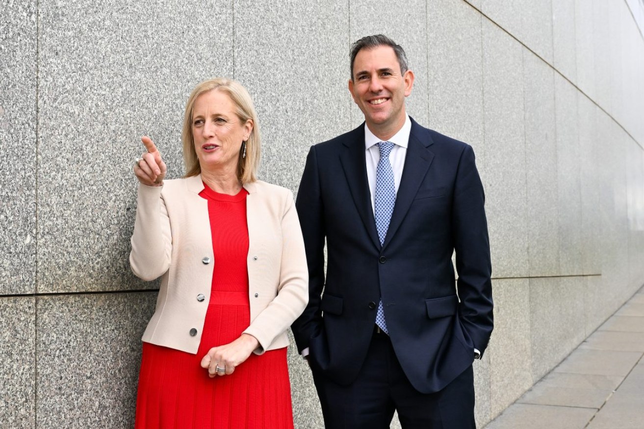 Australian Treasurer Jim Chalmers and Australian Finance Minister Katy Gallagher pose for photographs on the roof of Parliament House in Canberra, Wednesday, May 8, 2024. (AAP Image/Lukas Coch) 