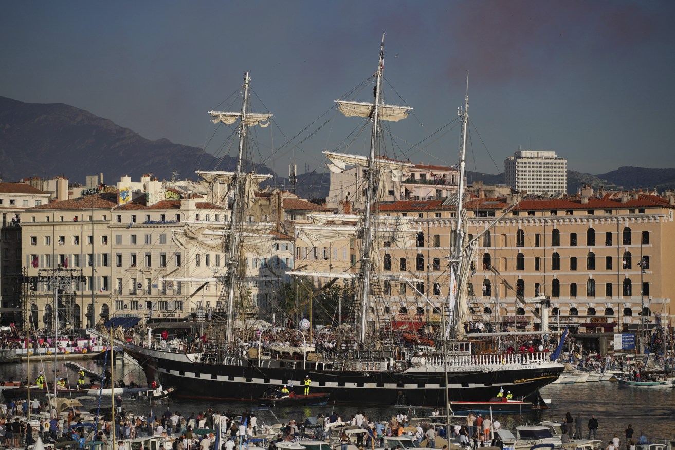 The Belem, the three-masted sailing ship which is carrying the Olympic flame, enters the Old Port in Marseille, southern France, Wednesday, May 8, 2024. The torch was lit in Greece last month before it was officially handed to France. The Paris 2024 Olympic Games will run from July 26 to Aug.11, 2024. (AP Photo/Daniel Cole)