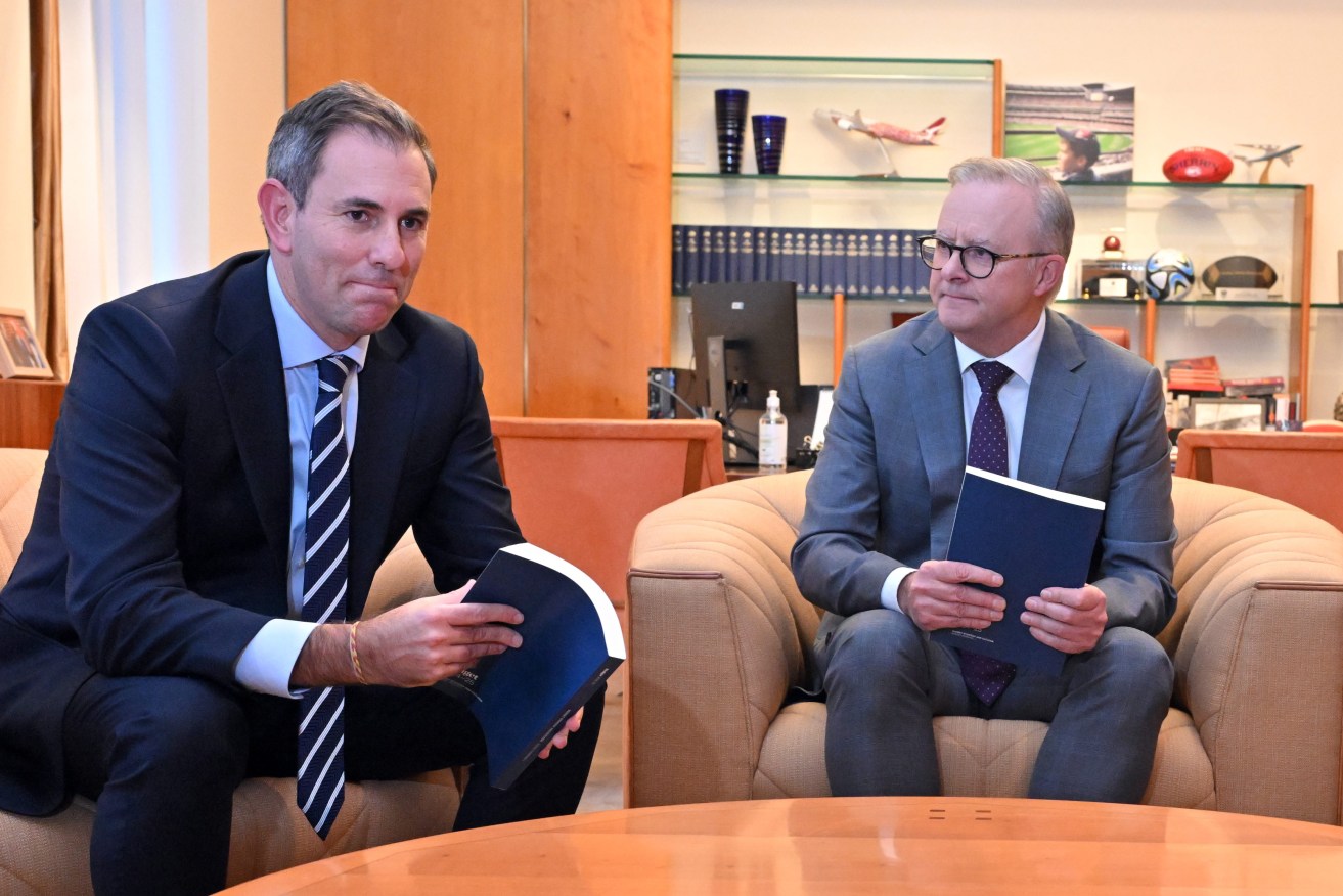 Treasurer Jim Chalmers and Prime Minister Anthony Albanese sit with copies of the upcoming Budget at Parliament House in Canberra, Monday, May 13, 2024. (AAP Image/Mick Tsikas) 