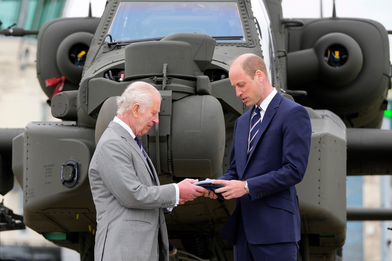 Britain's King Charles III officially hands over the role of Colonel-in-Chief of the Army Air Corps to Prince William, The Prince of Wales in front of an Apache helicopter at the Army Aviation Centre in Middle Wallop, England, Monday, May 13, 2024. (AP Photo/Kin Cheung, Pool)
